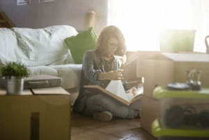 A Woman Getting Organized for Unpacking After a Move With Attention to Detail Moving