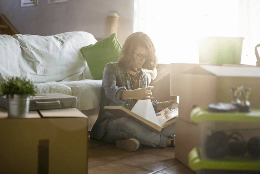 A Woman Getting Organized for Unpacking After a Move With Attention to Detail Moving