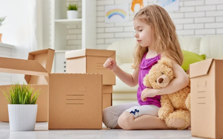Child Packing Things in Boxes to Move